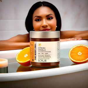 A woman sits in a bathtub with an orange, representing the refreshing effects of body scrubs on skin vitality.