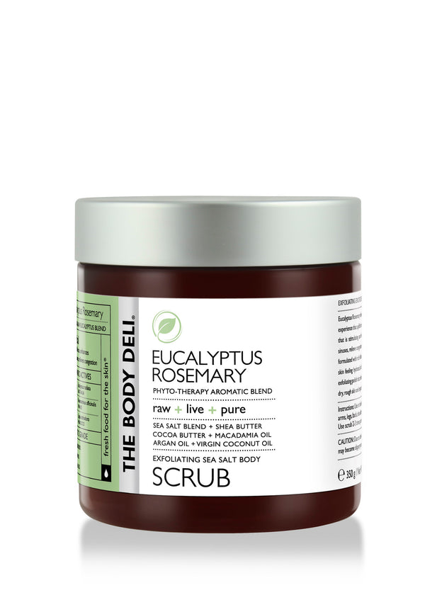 Eucalyptus rosemary body scrub in a glass jar, surrounded by fresh eucalyptus leaves and rosemary sprigs.