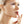 A woman gently rests her hand on her face, showcasing her peppermint lip balm with a serene expression